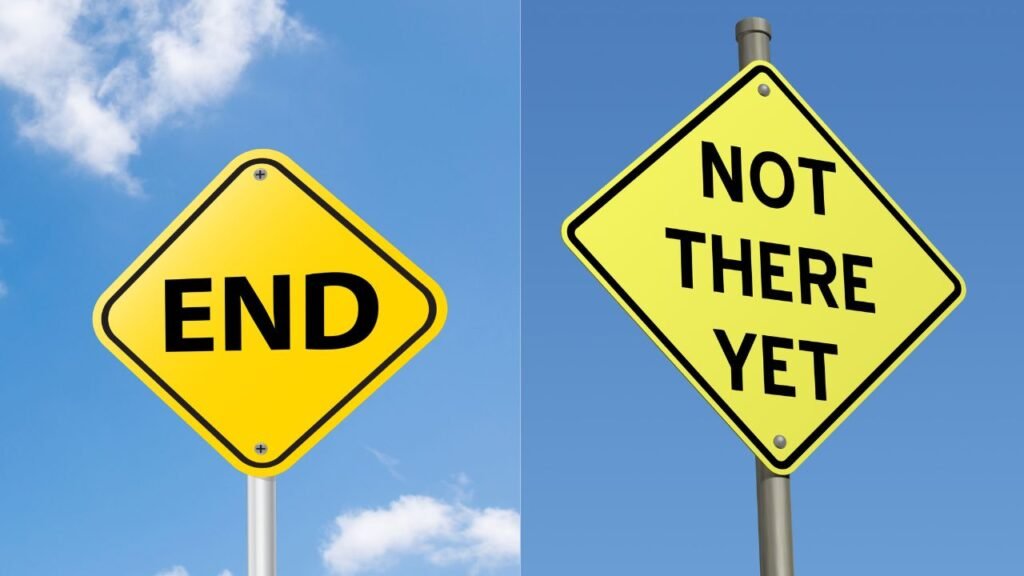 Road signs showing “End” and “Not There Yet,” representing uncertainty and progress in the Stages of Identity Shift