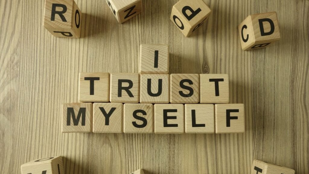Wooden letter blocks spelling “I TRUST MYSELF,” representing confidence and self-trust