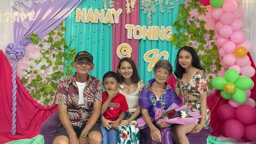 Ninety-Three Years of Love: What Lola Inay Taught Me About a Life Well Lived 9 Family posing with their grandmother during her 90th birthday celebration in front of a colorful balloon and floral backdrop